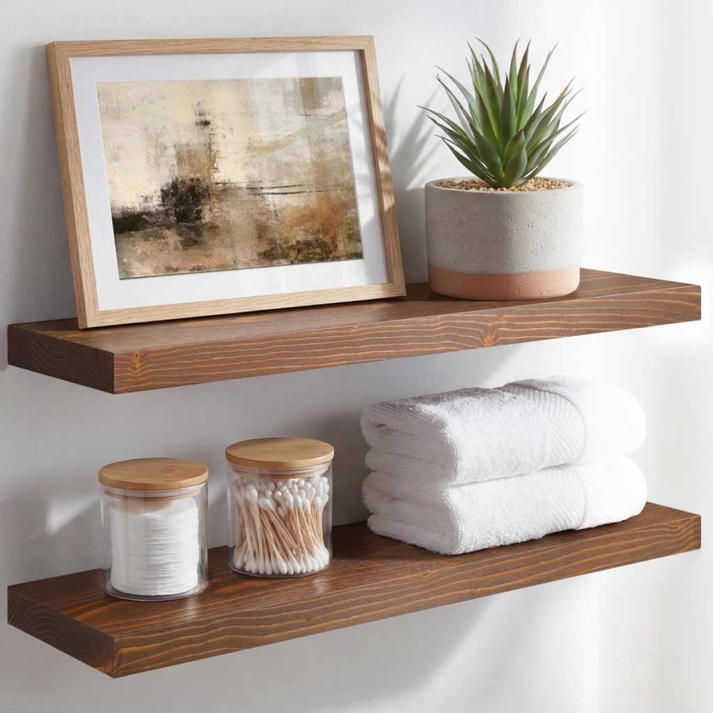 Wood Homeforia floating shelves styled in a modern bathroom with folded towels, small plants, candles, storage basket, round wall mirror, and neutral bathroom decor.