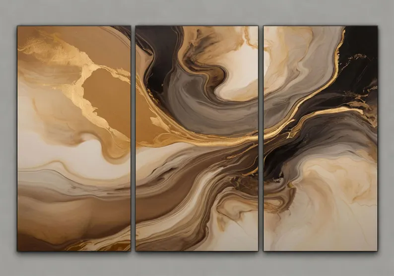 Gold and black abstract triptych wall art styled above a gray desk in a luxury home office with ergonomic chair, bookcase, plant, and neutral decor.