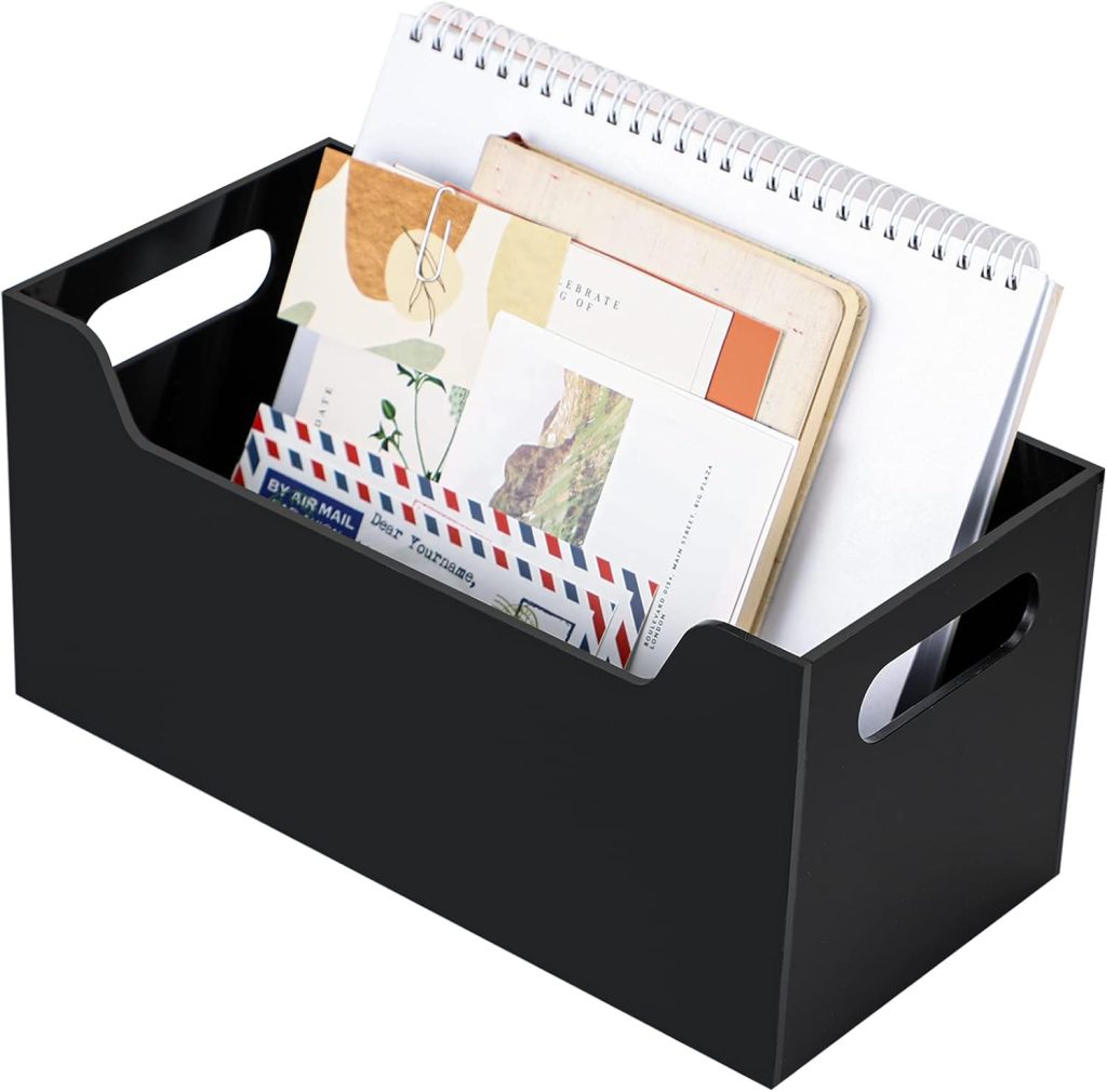Black acrylic mail organizer styled on a gray home office desk with lamp, ergonomic chair, triptych wall art, and neutral decor.