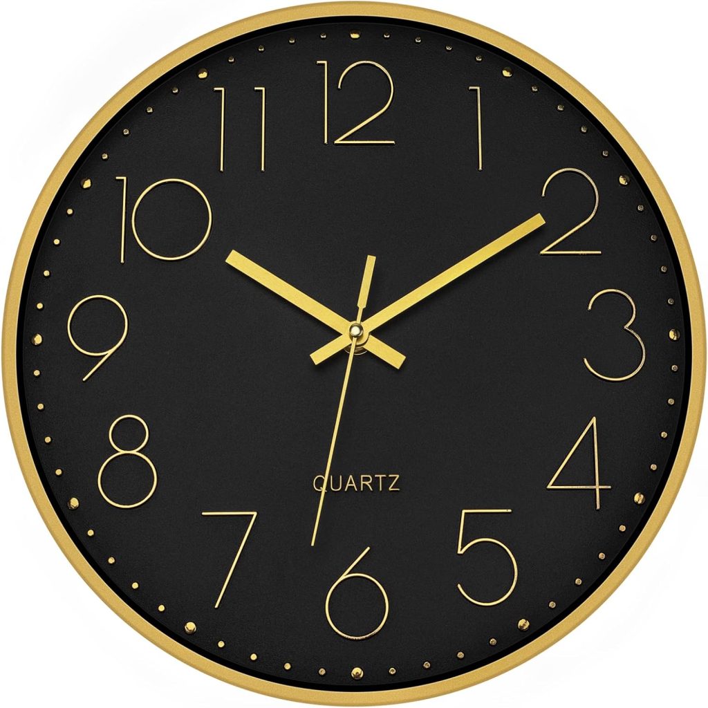 Black and gold silent wall clock styled in a modern home office with gray desk, ergonomic chair, triptych wall art, bookcase, and neutral decor.